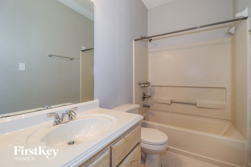 a bathroom with a sink and a shower and a toilet