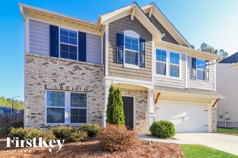 A house with a stone facade and a garage.