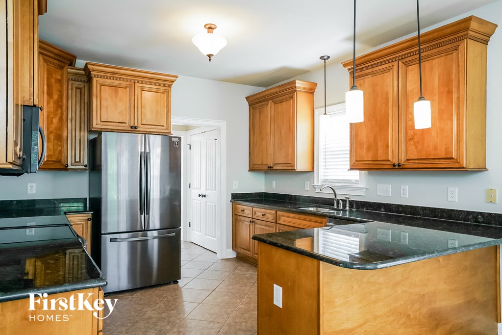 a kitchen with wooden cabinets and stainless steel appliances