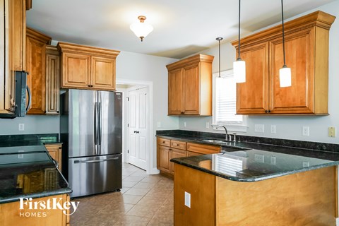 a kitchen with wooden cabinets and stainless steel appliances