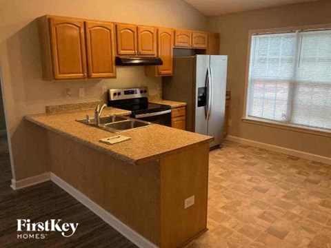 a kitchen with a sink and a refrigerator