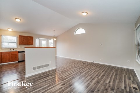 the living room is open to the kitchen and dining room