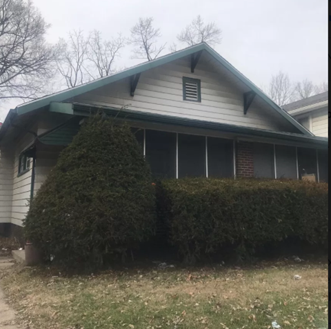 a house with hedges in front of it