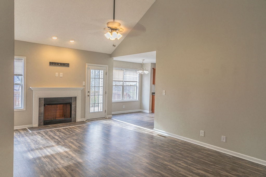 a empty living room with a fireplace