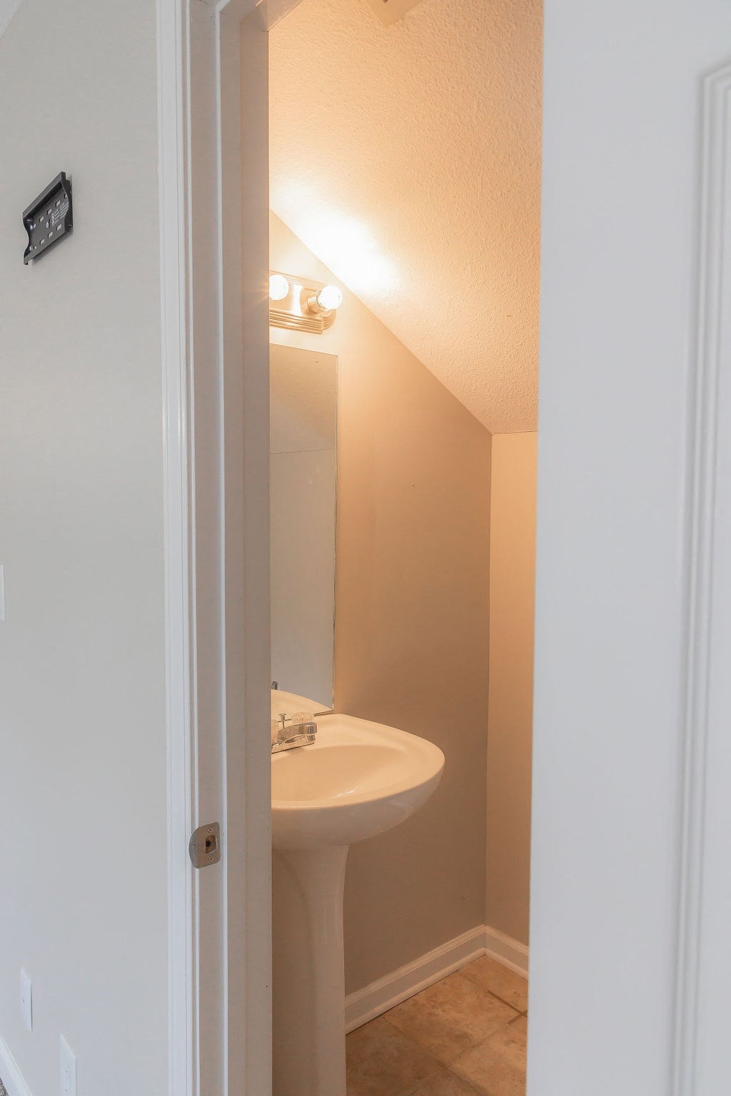 a small bathroom with a sink and a mirror