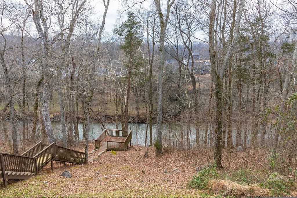 a view of a lake with two benches and a dock