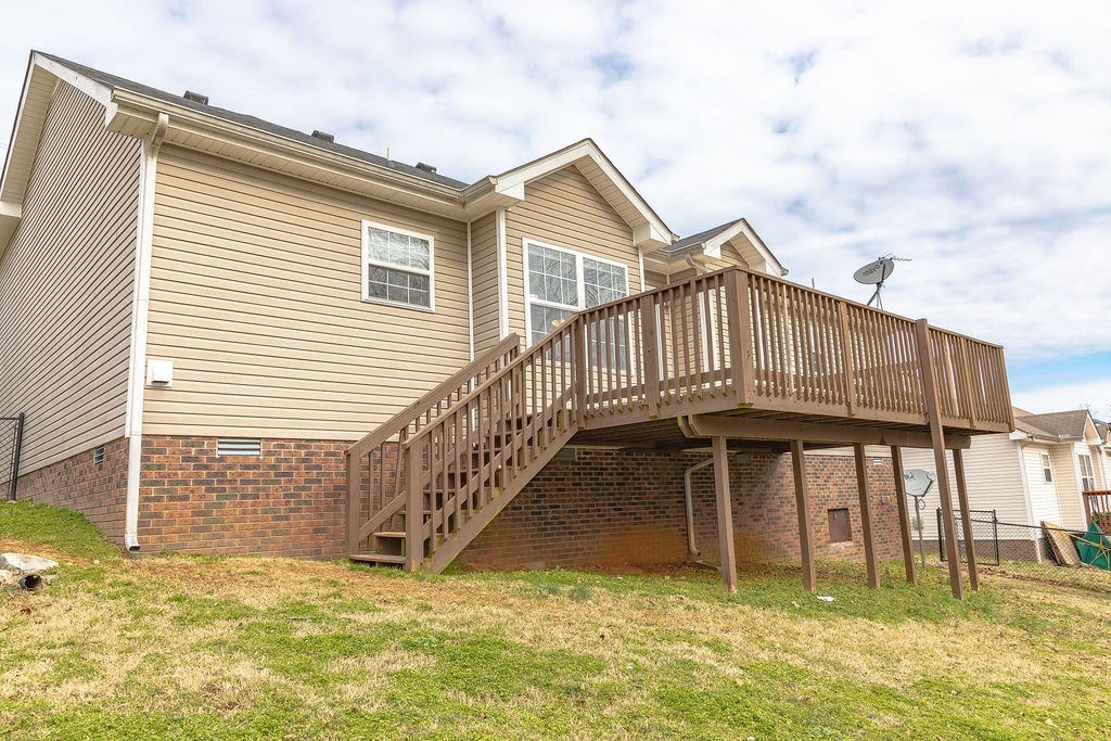 the back of a house with a wooden deck