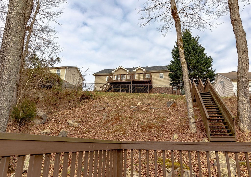the view of a house from a deck with stairs