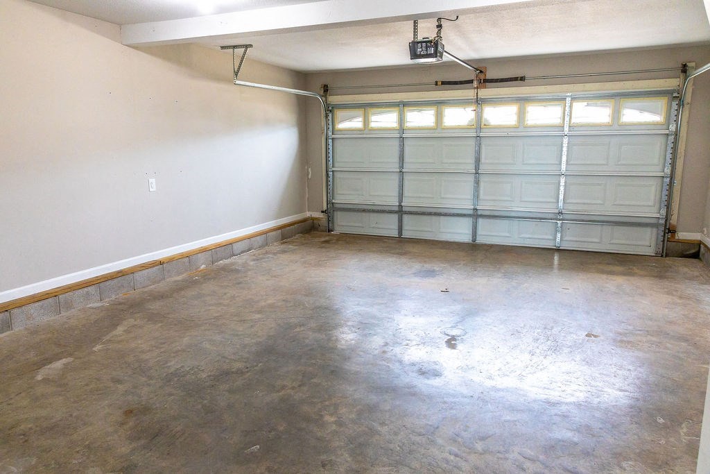 an empty garage with white walls and two garage doors
