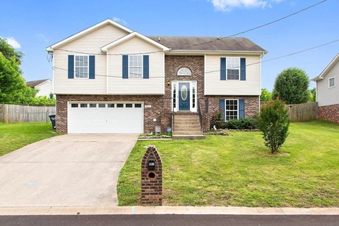 a house with a driveway and a garage door