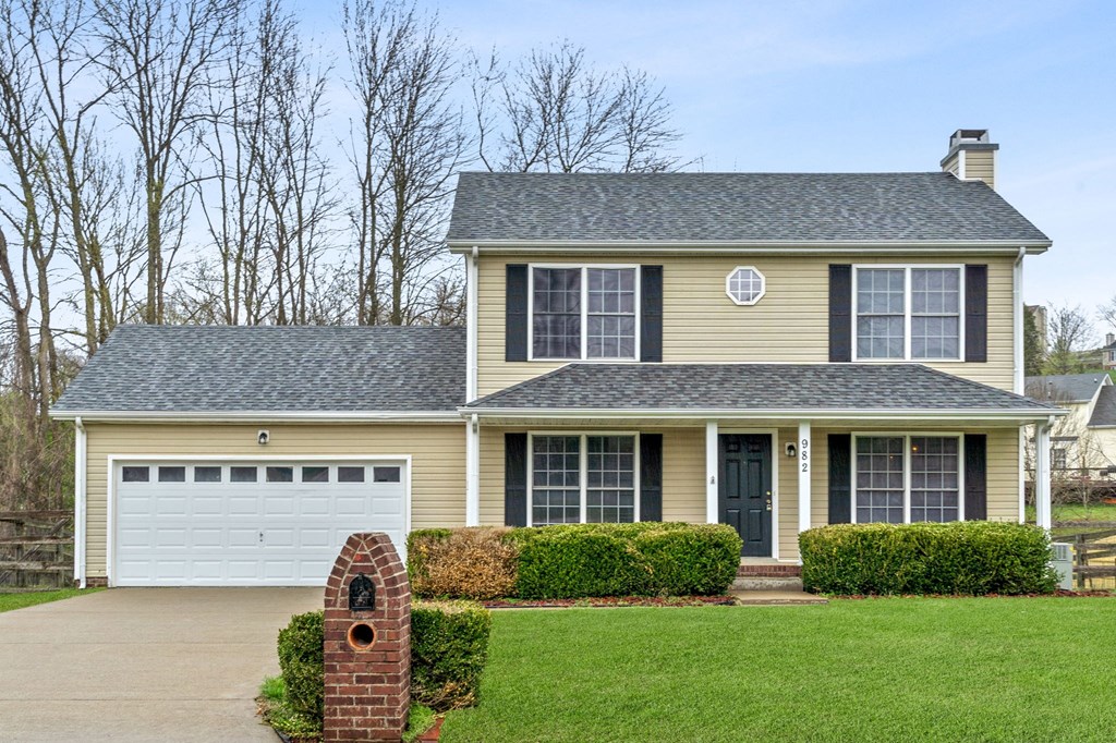 a yellow house with a mailbox in front of it