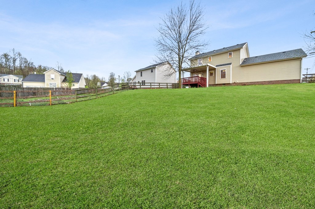 a large yard with a house in the background