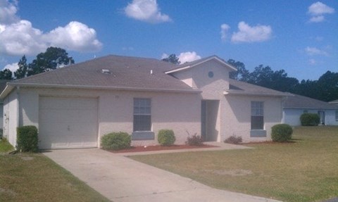a white house with a driveway and a garage door