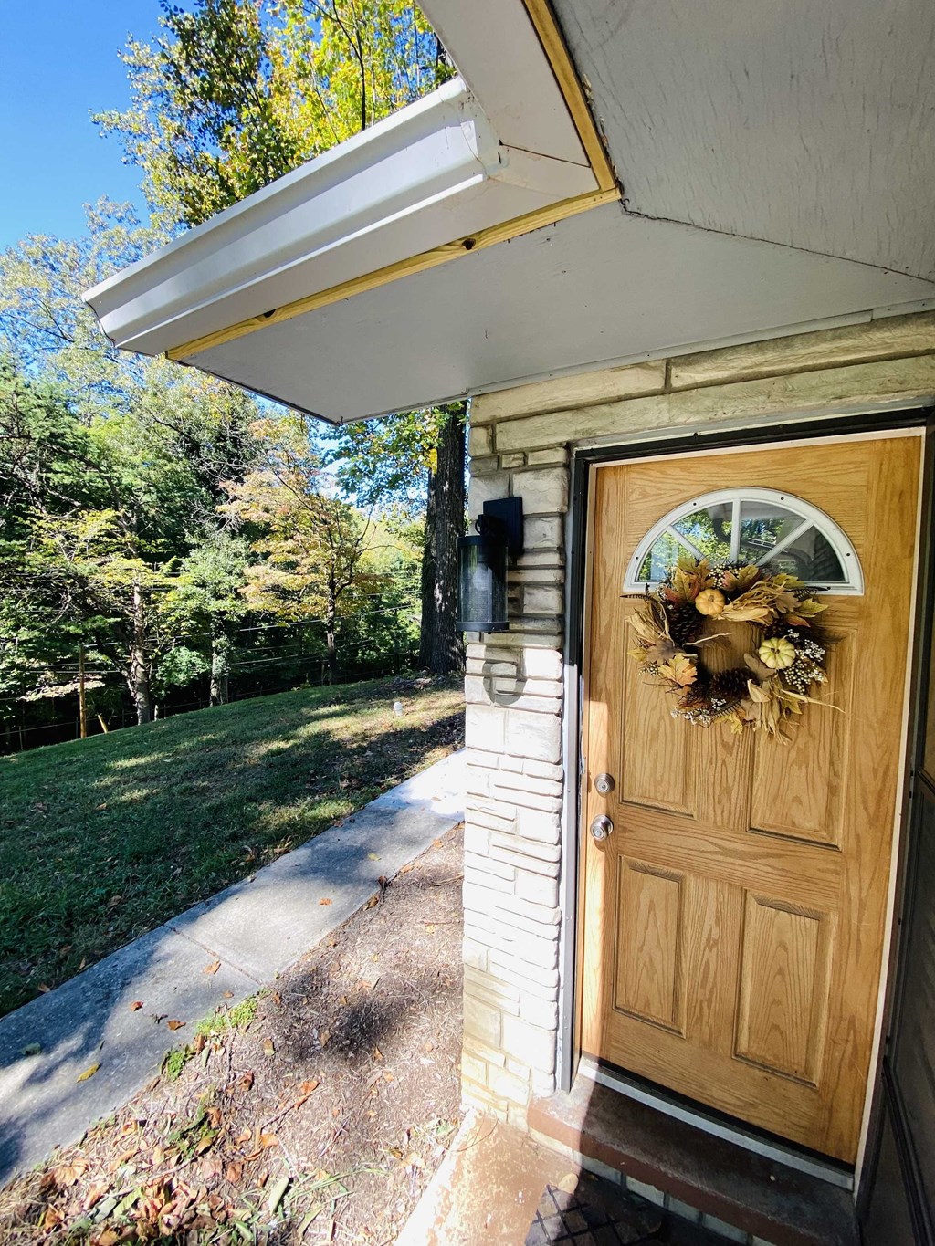 the front door of a house with a wreath on it