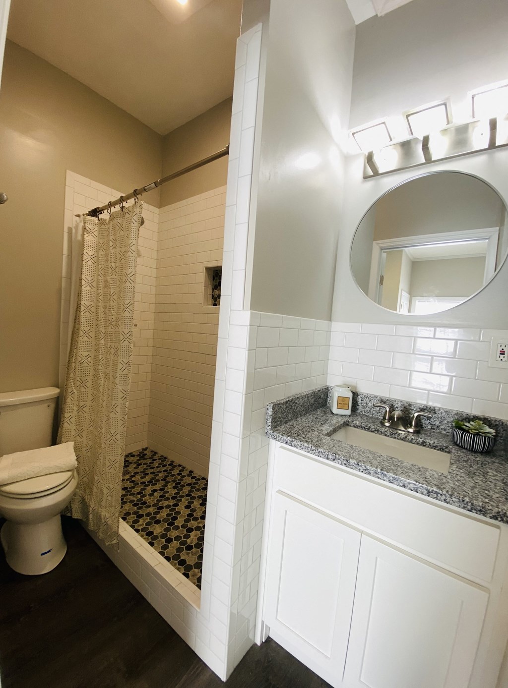 a bathroom with a shower and a sink and a mirror