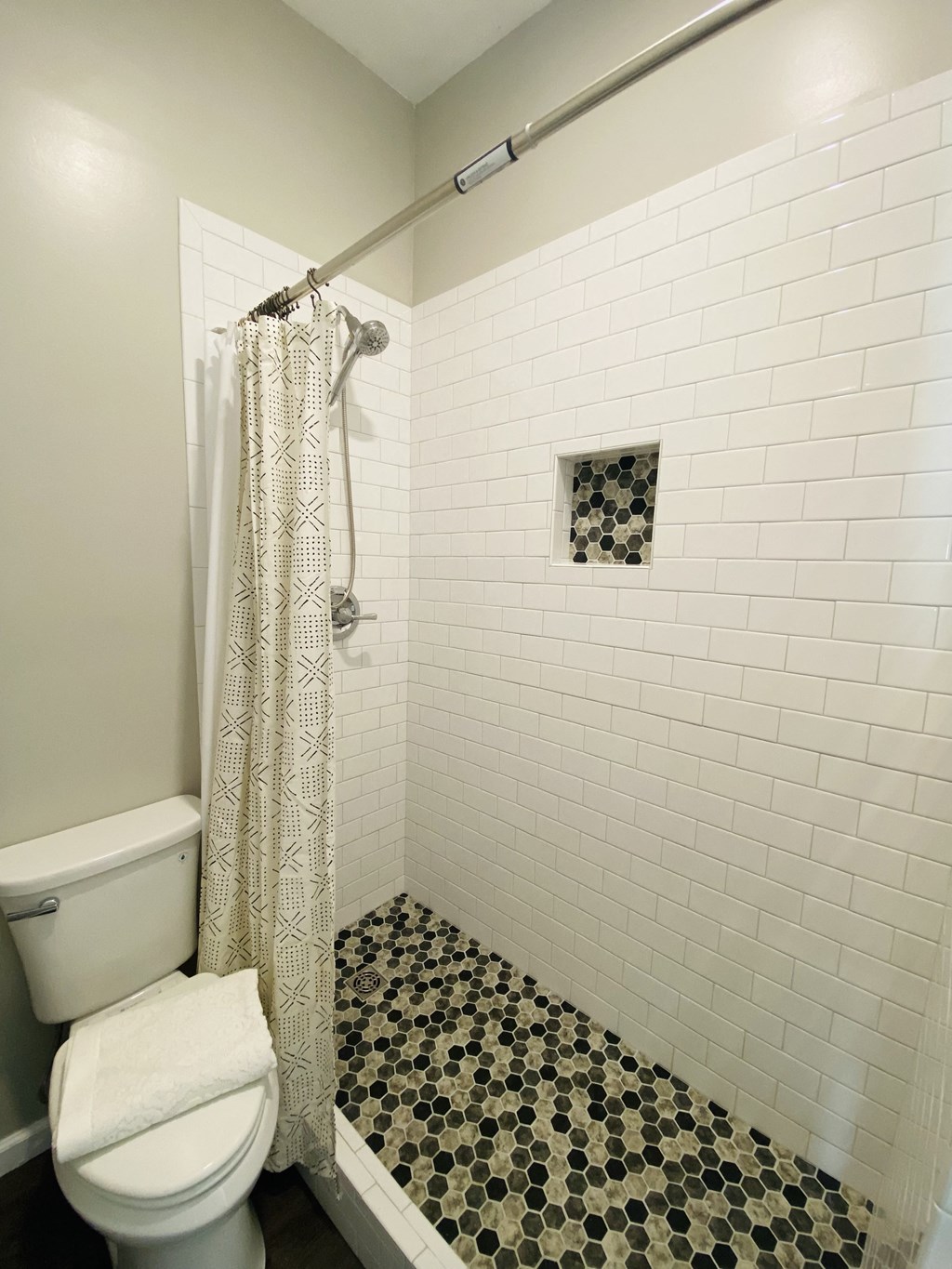 a bathroom with a toilet and a shower with a curtain