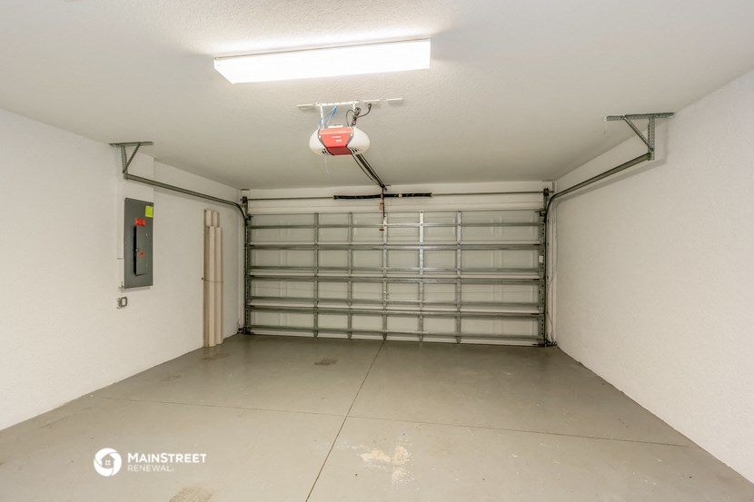 the garage is empty and ready to be converted into a home gym