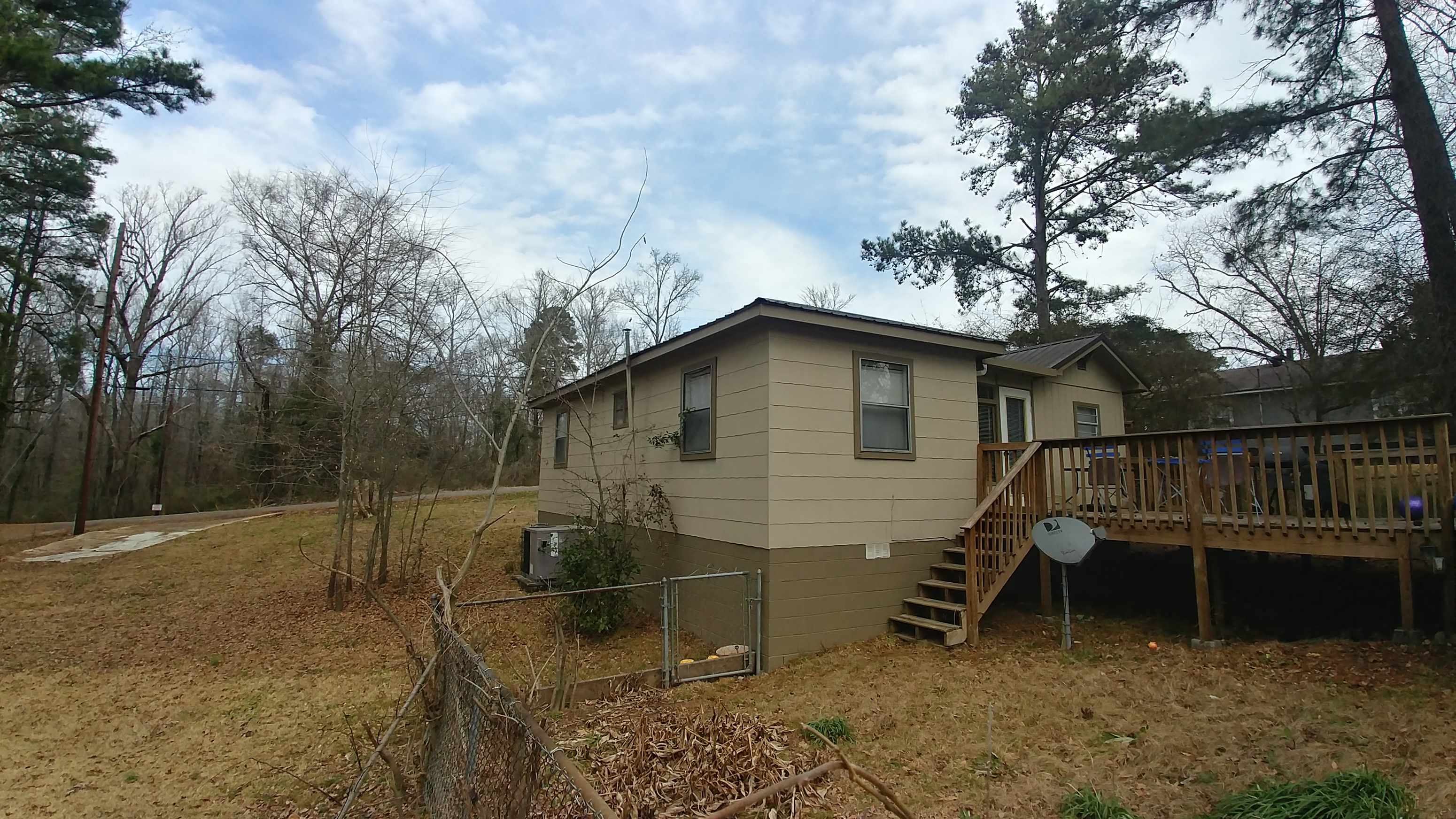 A house with a brown roof and a brown fence.