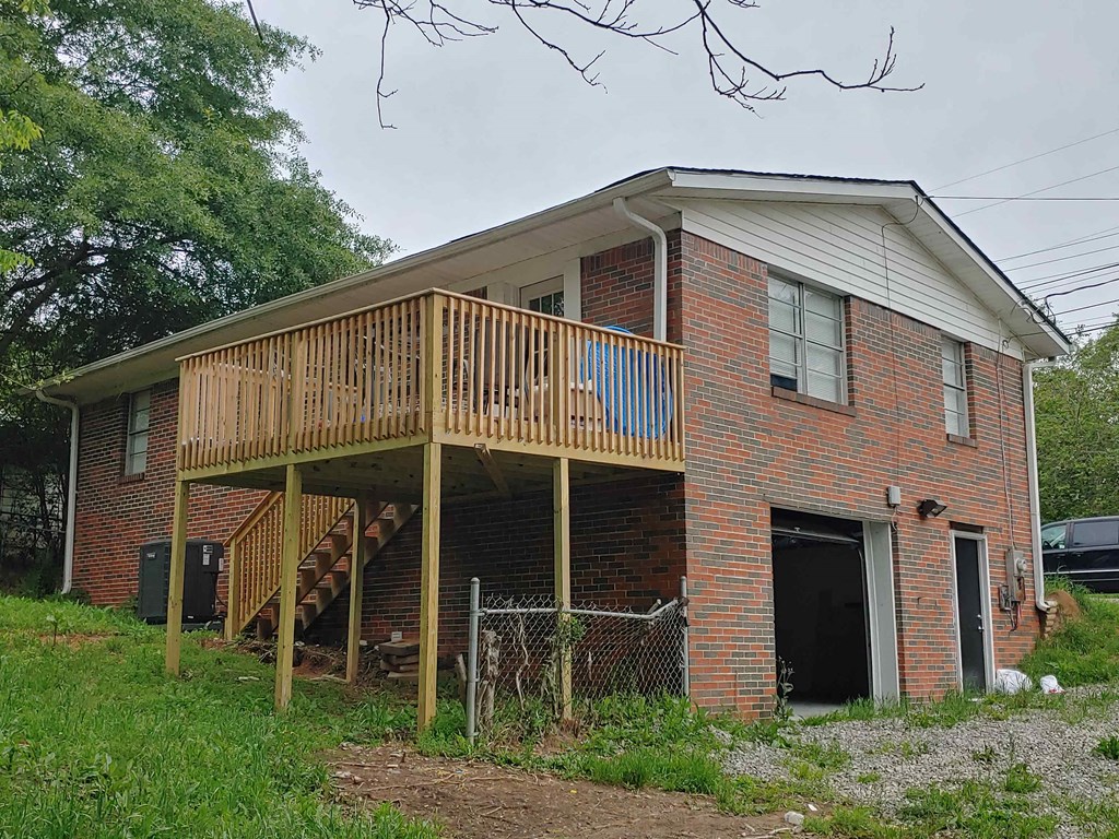 an old brick house with a deck on top of it
