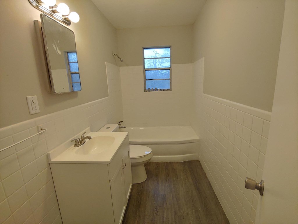 a bathroom with a sink toilet and a bath tub