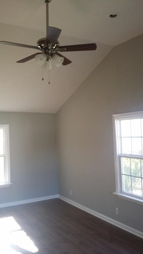 a living room with a ceiling fan and a window