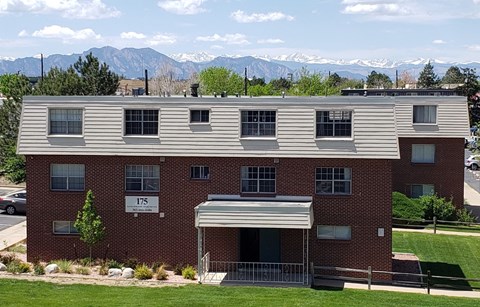 an apartment building with mountains in the background