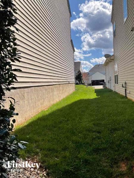 a grassy area between two buildings