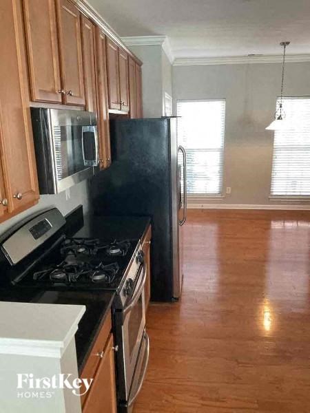 a kitchen with a stove and a refrigerator