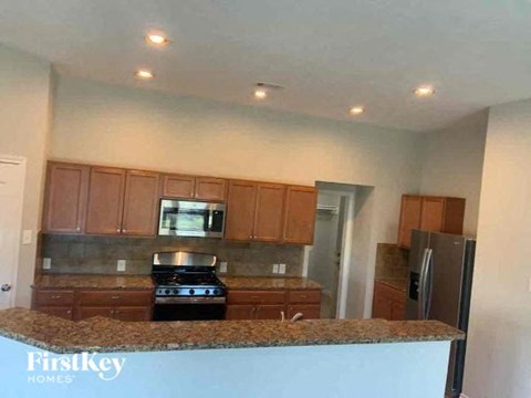 a kitchen with a granite counter top and a refrigerator