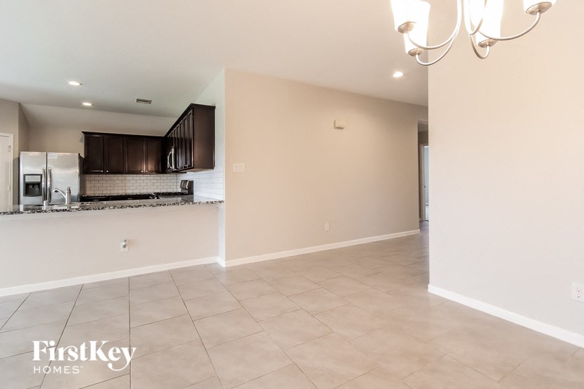 A spacious kitchen with a refrigerator, microwave, and oven.