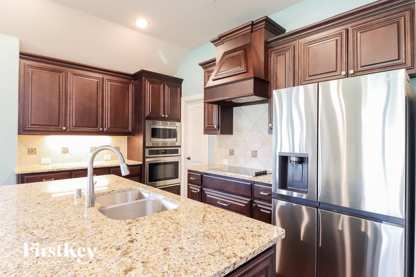 a kitchen with stainless steel appliances and granite counter tops