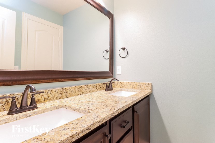 a bathroom with two sinks and a mirror