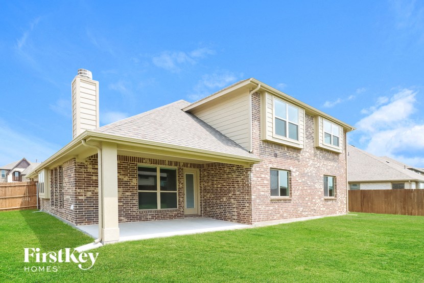 a brick house with a lawn and a yard