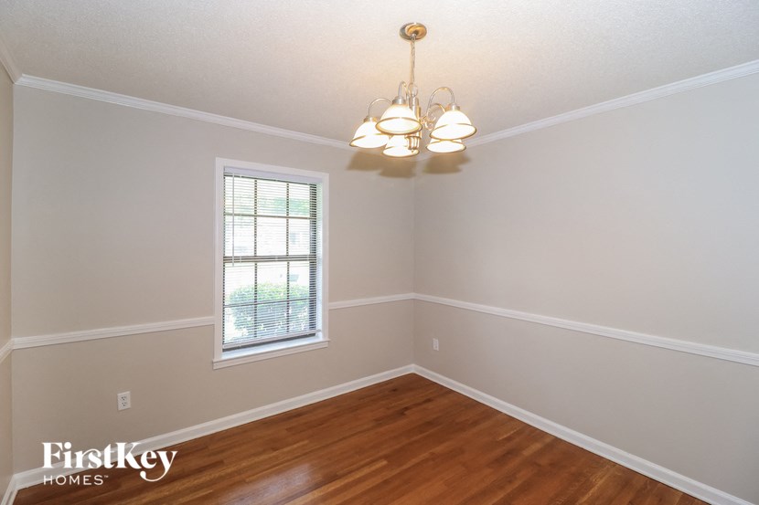 A room with a window and a chandelier.