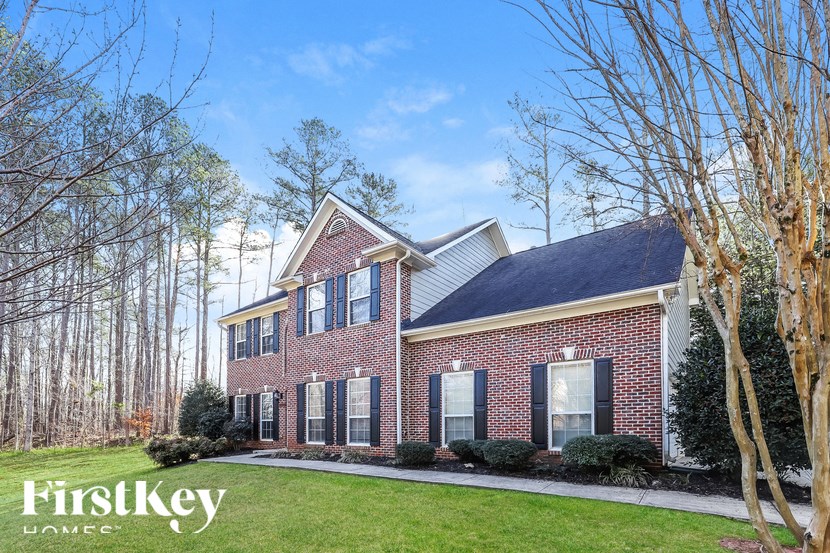 a brick house with a yard and trees