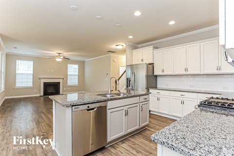 A kitchen with granite countertops and stainless steel appliances.