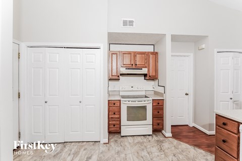 a kitchen with white appliances and wooden cabinets