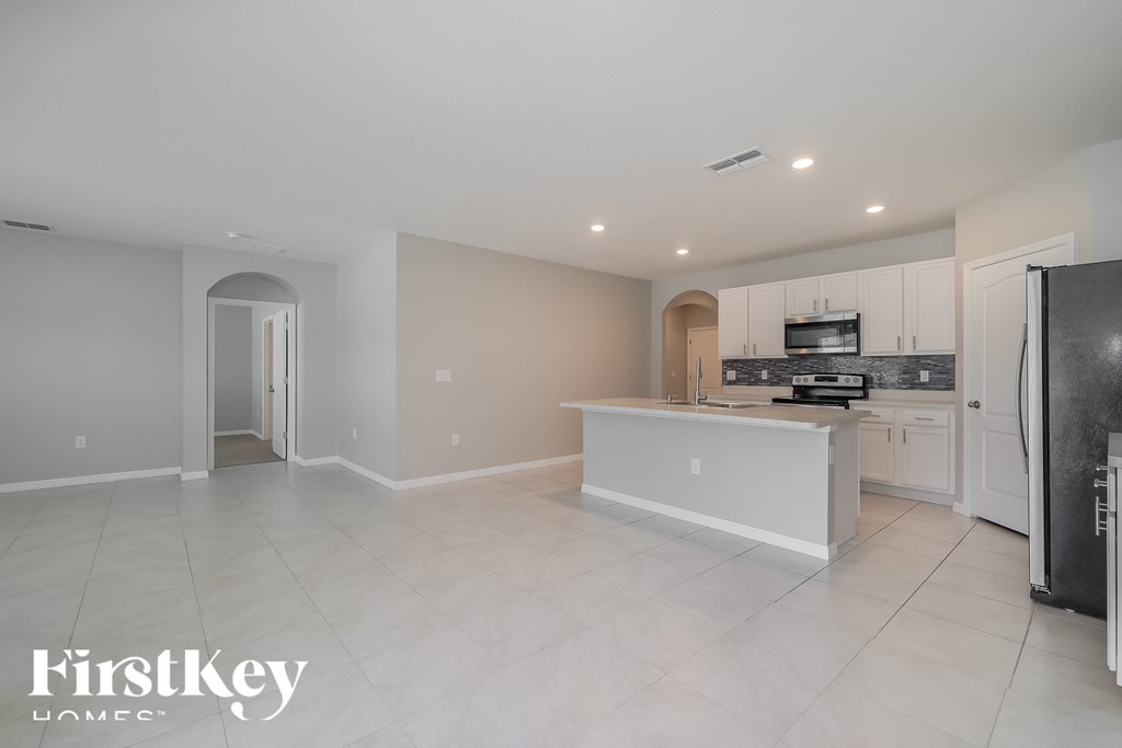 a large kitchen with white cabinets and a white counter top