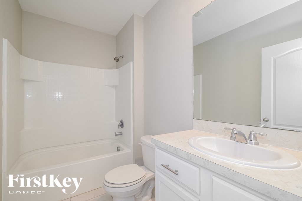 a bathroom with a sink toilet and a bath tub