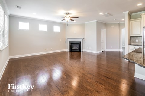 a living room with wood floors and a fireplace