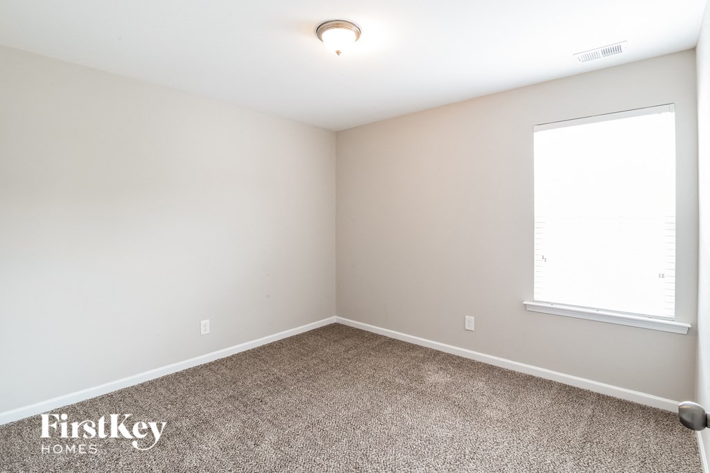 a room with a carpeted floor and a window