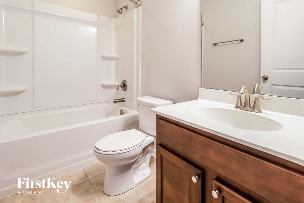 a bathroom with a sink toilet and a bath tub