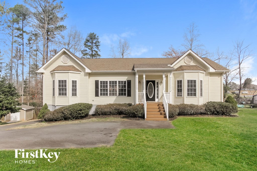 A house with a brown roof and a white front porch.