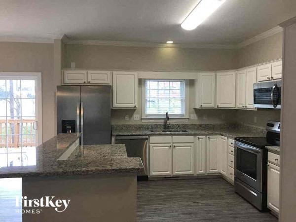 A kitchen with a granite countertop and stainless steel appliances.