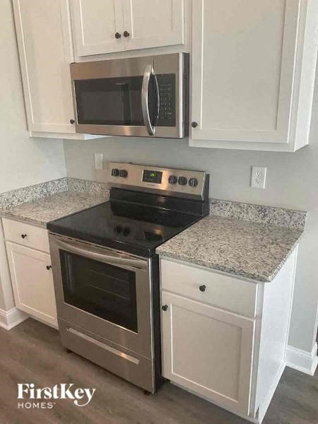 a kitchen with a stove and a microwave