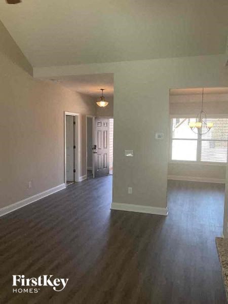 an empty living room with a hard wood floor
