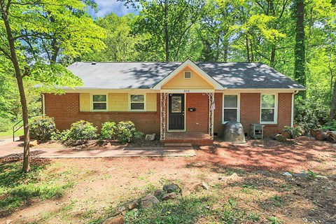 a small brick house in the middle of the woods