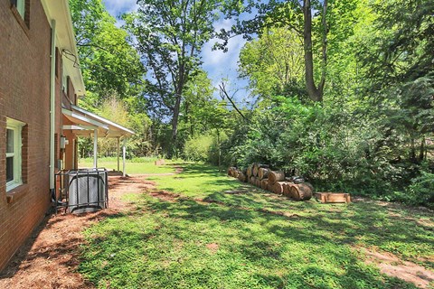 a yard with a house and some trees