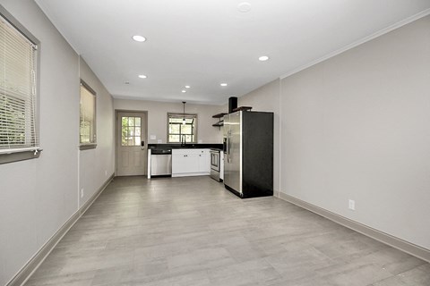 an empty kitchen with a refrigerator and a sink