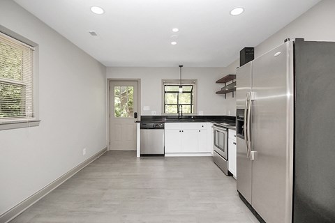 a kitchen with stainless steel appliances and white cabinets